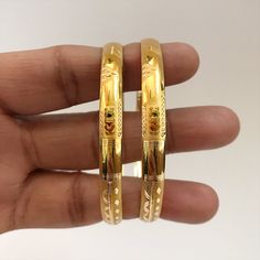 "Please contact us for any discounts or offers that are available on this item. As these gold bangles are very light in weight, after making these bangles, we put a protective metal bangle on the inner surface of the original gold bangles, as shown in the 4th image, this provides strength & shape to the bangles. Please Note:- The bangles are made out of Real Solid Gold & the metal bangles are just for support & durability. All Sizes available. We take absolute care of precious jewels Trendy Gold Bangle At Affordable Price, Cheap Yellow Gold Round Bangle, Solid Gold Bangles Indian, Gold Bangles Design Daily Wear Latest, Gold Bangles Indian, Gold Bangles For Women, Yellow Gold Bangle, Bangles Indian, Gold Bangles Design