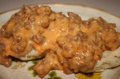 a plate topped with meat covered in gravy