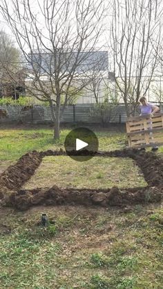 two people are working in the yard to build a house out of dirt and grass