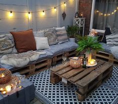 an outdoor living room with lights strung over the couches