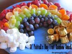 a blue plate topped with fruit and marshmallows