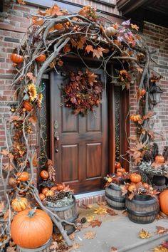 a front door decorated with pumpkins and vines