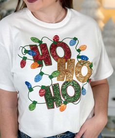 Elevate your festive style with our "Faux Sequin Ho Ho Ho Graphic Shirt." This cheerful shirt features a delightful graphic design of the words "Ho Ho Ho" adorned with a string of Christmas lights, all in faux sequins. Please note that these are graphic sequins, providing a sparkling appearance without the actual texture of real sequins.Our faux sequin design is not shiny/sparkly. This is a printed graphic design that is meant to give the look of sequins, it is not real sequins. It does look exactly like the photo as this is a printed graphic tee that shows the actual design printed on the tee.
Perfect for holiday gatherings, spreading cheer, or just adding a touch of merriment to your everyday look, the "Faux Sequin Ho Ho Ho Graphic Shirt" captures the festive spirit with a playful and co Homemade Shirts, Black Friday Christmas, Sequin Design, Holiday Sweatshirt, Ho Ho Ho, Holiday Gathering, Graphic Shirt, Christmas And New Year, The Words