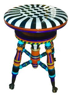 an artistically designed stool with wheels and colorful paint on it's legs,