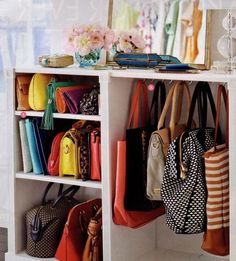 purses and handbags are hanging on the shelf