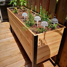 a wooden planter filled with lots of plants