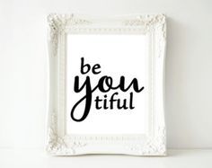 a white frame with the words be you tiful written in black ink on it