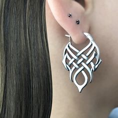 Unique Celtic Knot hoops earrings are made of 316 Stainless steel. Size of the hoop : 38mm long, 27mm wide Standard Post 22G Sold as 1 Pair Ships in a gift box *RETURNS / REFUNDS * -If you would like to return you purchase , please contact us within 7 days of receiving your package and we will accept the return.Return will only be made to the product, and not the shipping cost.  -Buyer is  responsible for the return shipping costs . -All jewelry must be returned unworn and in their original condition . *LOST MAIL* Once the package is marked as DELIVERED by the post office, we are not responsible for misplaced or stolen packages. *MAIL THEFT* If parcel is stoled or vandalized, please contact USPS mail theft department for further directions. We are not responsible for mail theft or vandalis Jewelry Hoop Earrings, Celtic Moon, Celtic Knot Earrings, Celtic Earrings, Front Back Earrings, Gothic Earrings, Symbolic Jewelry, Hoops Earrings, Knot Earrings