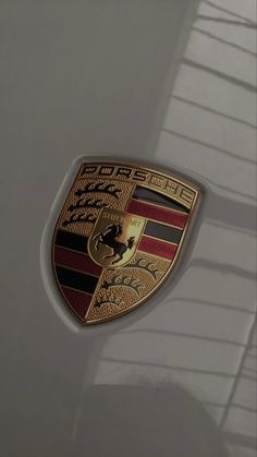 an image of a porsche emblem on the side of a car