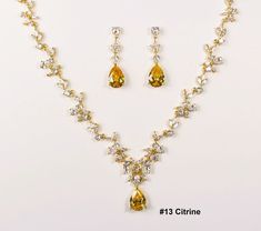 "The default will be: \"Citrine CZ Stone, Kraft/Tan box with twine & no message\". If you need different colored Stone, please check the stone color chart in last photo & specify the color number in checkout notes section. This three pieces jewelry set is made with high quality AAA cubic zirconia on triple white gold plated set. The necklace has 15 CZ sections linked with a Teardrop CZ pendant size of 12 x16mm. Total length is 17-19 inches adjustable. Let me know if you would like customized to Citrine Wedding, Wedding Jewelry Set, Bridal Jewelry Set, Gold Bridal Earrings, Zirconia Necklace, Necklace Bridal, Cubic Zirconia Necklace, Cubic Zirconia Jewelry, Colored Stone