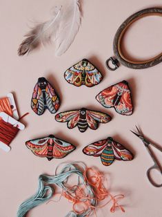 some scissors, thread and other items on a table