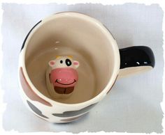 a ceramic cow head in a coffee cup