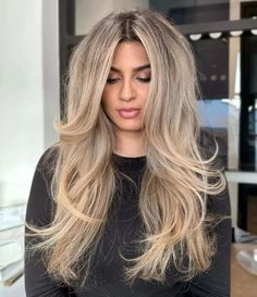 Dive into the elegance of blonde balayage, where ash and honey hues intertwine, shimmering in the light. Long, flowing layers add body, and a voluminous blowout sweeps gracefully, contouring the face. Perfect for adding length and vibrancy. Curious? Click to view our gallery and get more inspiration on Pinterest! ** Photo Credit: Instagram @styledxsierra Root Balayage, Voluminous Blowout, Birthday Hair