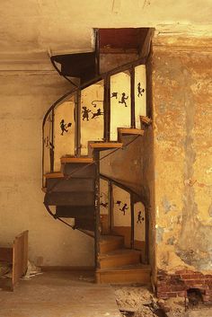 a spiral staircase in an abandoned building