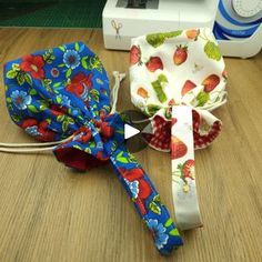 two bows tied together on a table next to a sewing machine and some other items