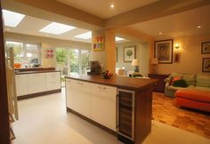 an open kitchen and living room area in a house