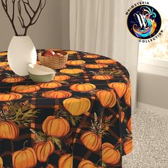 a table topped with a bowl of fruit and a vase filled with orange pumpkins