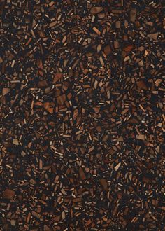 a brown and black surface with small pieces of wood