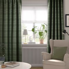 a living room filled with furniture and green curtains