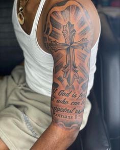 a man with a cross tattoo on his arm