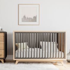 a baby's crib in the corner of a room next to a dresser