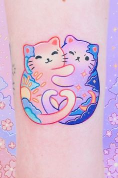 two cats hugging each other on the side of a woman's leg with flowers in the background