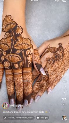 two hands with henna designs on them, one is holding the other's hand