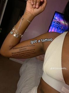 a woman with a tattoo on her arm and the words got a tattoo written in it