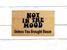 a door mat that says not in the mood unless you brought booze