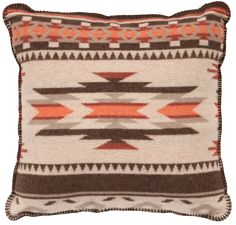 a brown and white pillow with orange accents