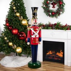 a toy soldier standing in front of a christmas tree