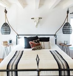 a bed with black and white bedspread in a bedroom