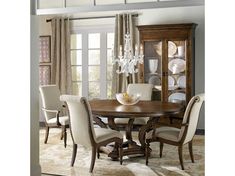 a dining room table with chairs and a china cabinet