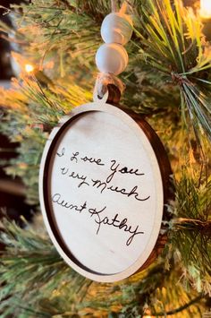 a wooden ornament hanging from a christmas tree with the words, i love you so much it's my birthday