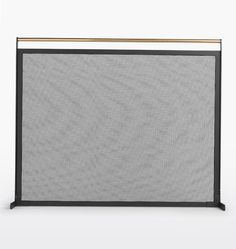 a black and gold fireplace screen with an iron bar at the top, on a white background