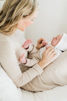 a woman holding a baby in her arms