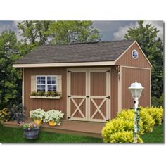 a garden shed is shown with flowers and plants in the front yard, along with a lamp post