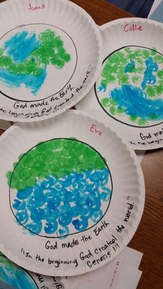 four paper plates with different designs on them, one has water and the other has land