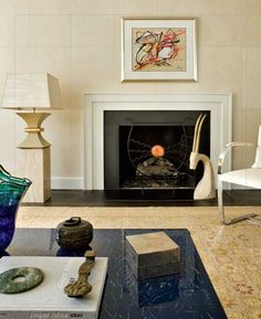 a living room filled with furniture and a fire place in the middle of the room