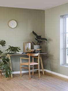 a table with two chairs and a clock on the wall