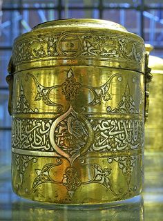 an ornate gold box sitting on top of a table