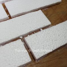 several pieces of white cake sitting on top of a wooden table