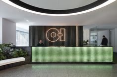 an office lobby with green and white tiles