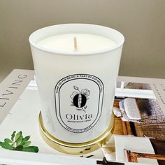 a white candle sitting on top of a table