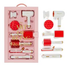 an assortment of red and white hair brushes in a pink box with gold trimming tools