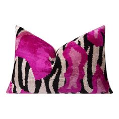 a pink and black pillow with zebra print