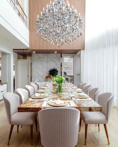 a dining room table with chairs and a chandelier