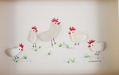 three chickens are standing in the grass on a white background, and one is painted red