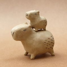 two ceramic animals sitting on top of each other