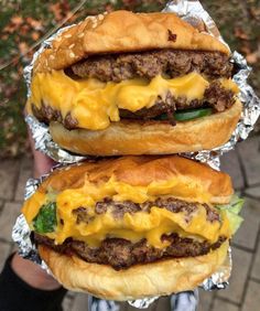 two cheeseburger sandwiches sitting on top of each other